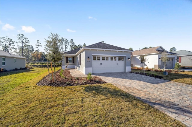 view of front of house with a garage and a front lawn