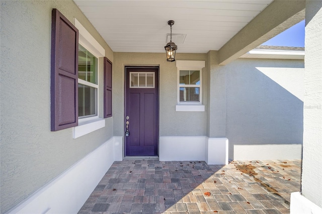 doorway to property featuring covered porch