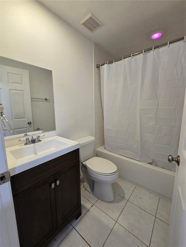 full bathroom featuring tile patterned flooring, vanity, shower / bath combination with curtain, and toilet