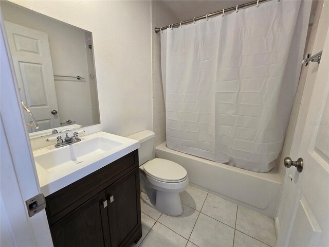 full bathroom featuring tile patterned flooring, vanity, shower / tub combo with curtain, and toilet