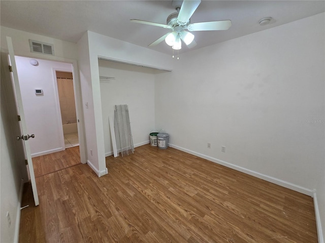 unfurnished room featuring hardwood / wood-style floors and ceiling fan