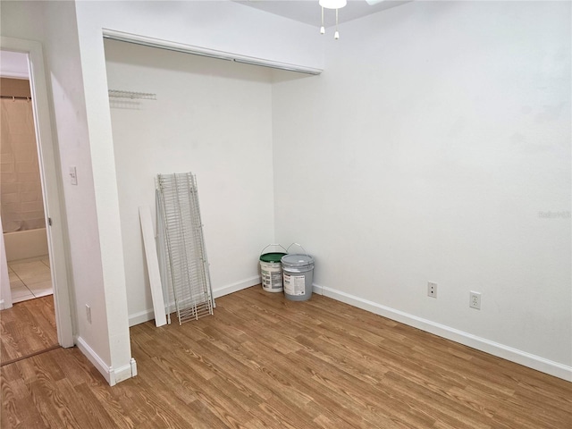 clothes washing area with hardwood / wood-style floors