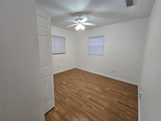 empty room featuring ceiling fan and wood-type flooring