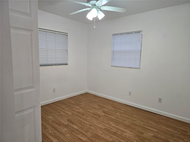 empty room featuring hardwood / wood-style floors and ceiling fan