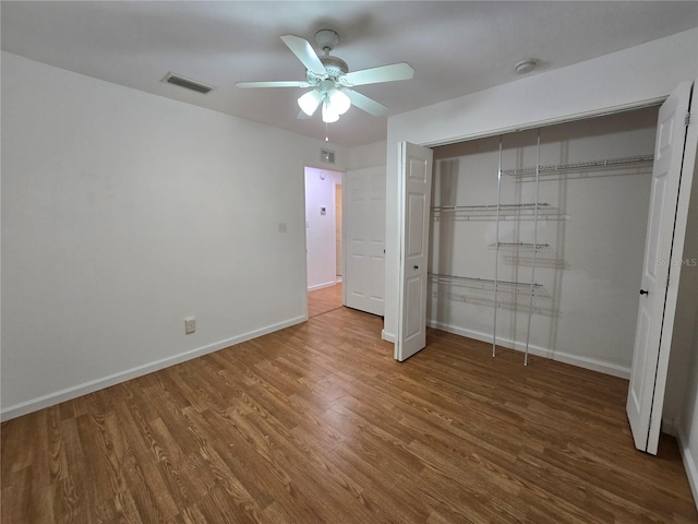 unfurnished bedroom with a closet, ceiling fan, and hardwood / wood-style floors