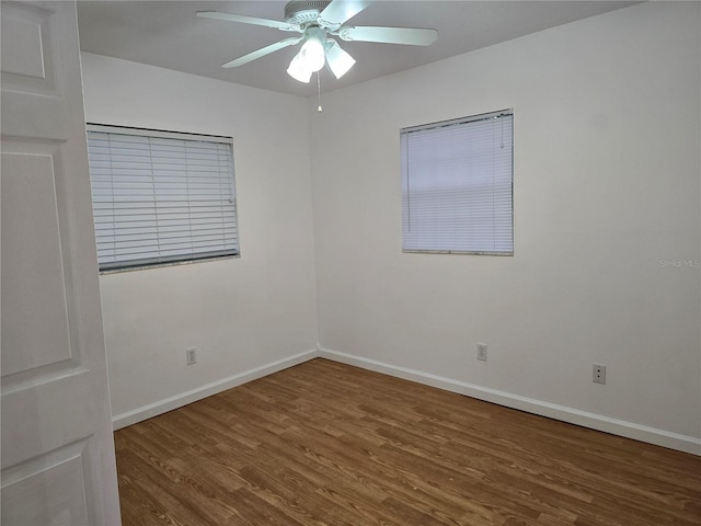 empty room with dark hardwood / wood-style floors and ceiling fan