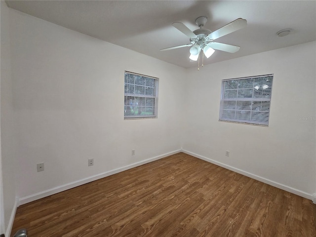 spare room featuring ceiling fan and dark hardwood / wood-style flooring