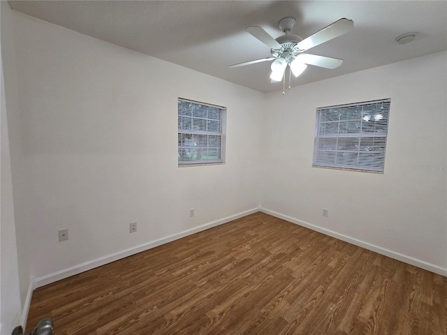 empty room featuring dark hardwood / wood-style flooring and ceiling fan