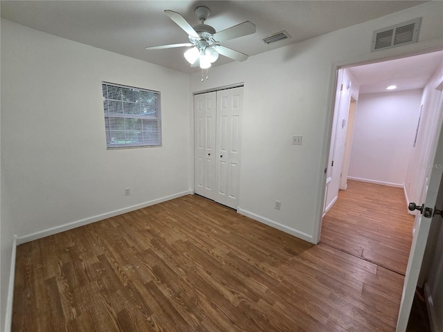 unfurnished bedroom with a closet, ceiling fan, and hardwood / wood-style flooring