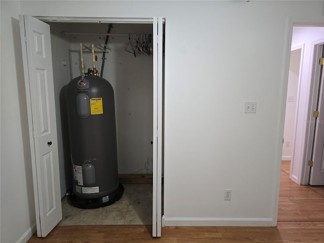 utility room featuring water heater