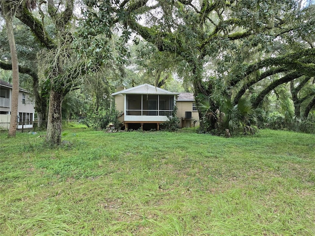 view of yard featuring a sunroom