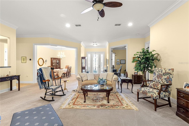 living room featuring light carpet, ceiling fan with notable chandelier, and ornamental molding