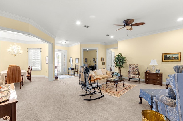 living room featuring ceiling fan with notable chandelier, ornamental molding, and light carpet