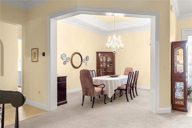 carpeted dining area featuring an inviting chandelier and crown molding