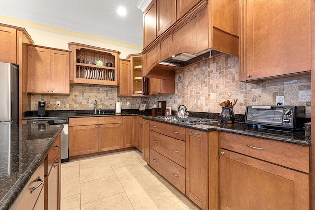 kitchen with tasteful backsplash, ornamental molding, custom exhaust hood, dark stone counters, and sink