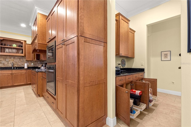 kitchen with decorative backsplash, stainless steel appliances, crown molding, sink, and light tile patterned floors