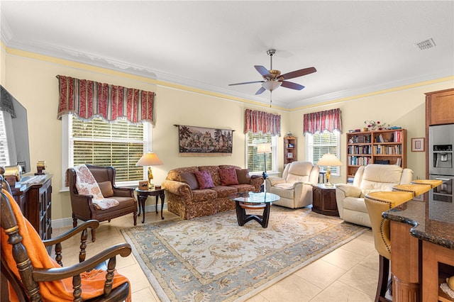 living room featuring ceiling fan, light tile patterned flooring, and ornamental molding