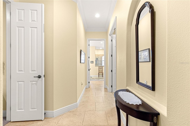 hall featuring light tile patterned flooring and ornamental molding