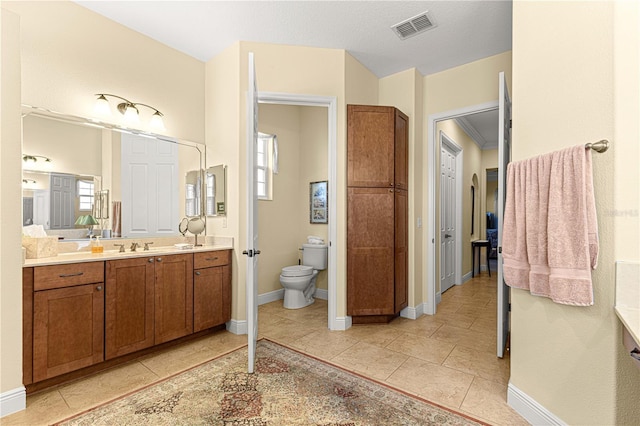 bathroom with tile patterned floors, vanity, and toilet