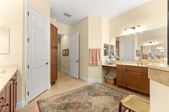 bathroom featuring tile patterned flooring and vanity