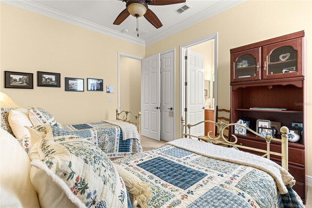 bedroom with carpet flooring, ceiling fan, and crown molding