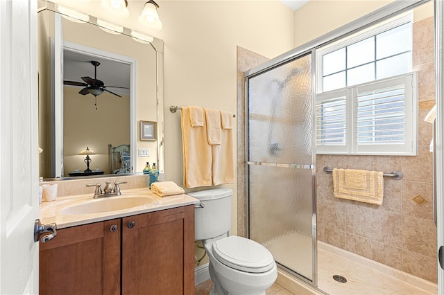 bathroom featuring an enclosed shower, vanity, toilet, and ceiling fan