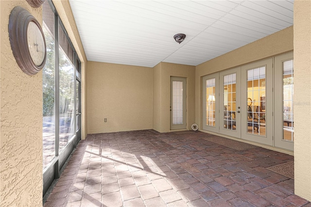 unfurnished sunroom featuring french doors