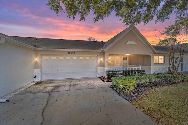 view of front of property featuring a porch and a garage