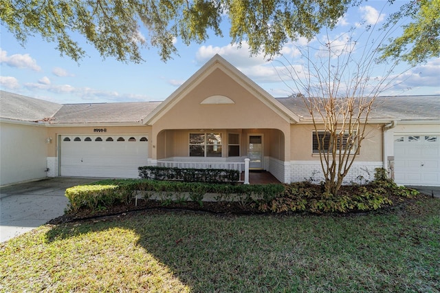 ranch-style house with a porch, a garage, and a front lawn