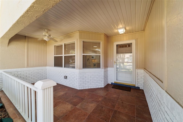 view of exterior entry featuring a patio area and ceiling fan