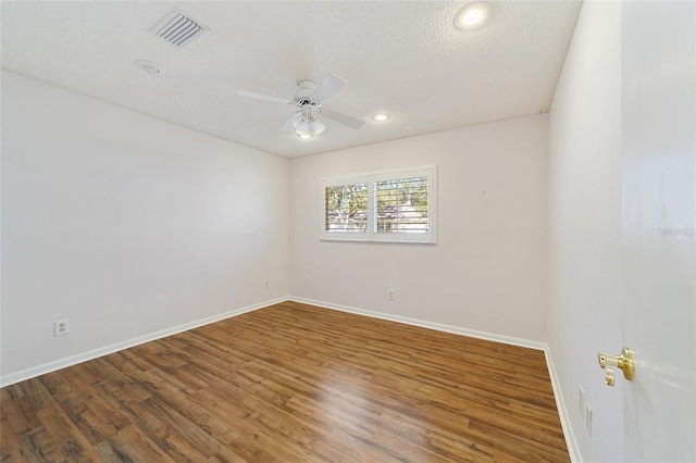 unfurnished room featuring a textured ceiling, ceiling fan, and dark wood-type flooring