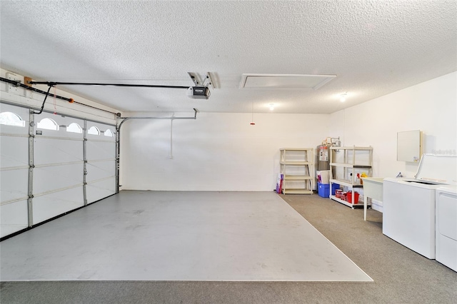 garage featuring separate washer and dryer, electric water heater, and a garage door opener