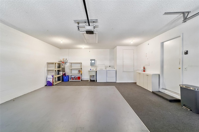 garage with a garage door opener and washing machine and clothes dryer