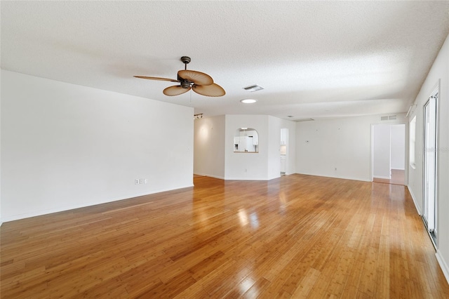 interior space with ceiling fan, light hardwood / wood-style flooring, and a textured ceiling