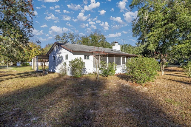 view of front of home featuring a carport and a sunroom