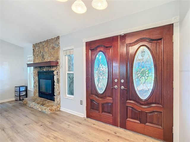 foyer featuring a fireplace and light hardwood / wood-style flooring