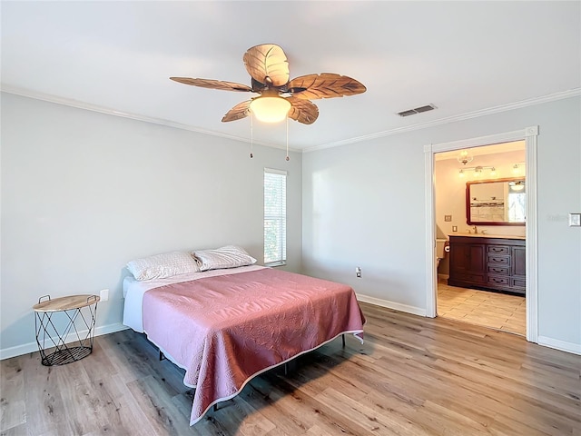 bedroom featuring ceiling fan, ensuite bathroom, light hardwood / wood-style floors, and ornamental molding