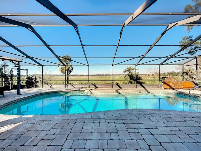 view of swimming pool featuring glass enclosure and a patio area