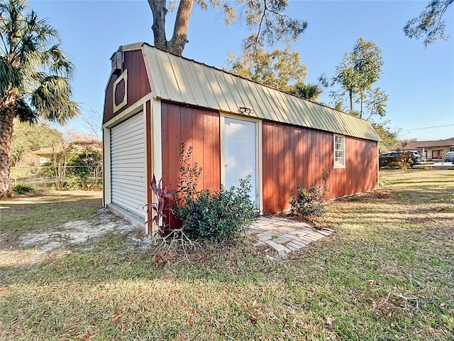 view of outdoor structure featuring a lawn