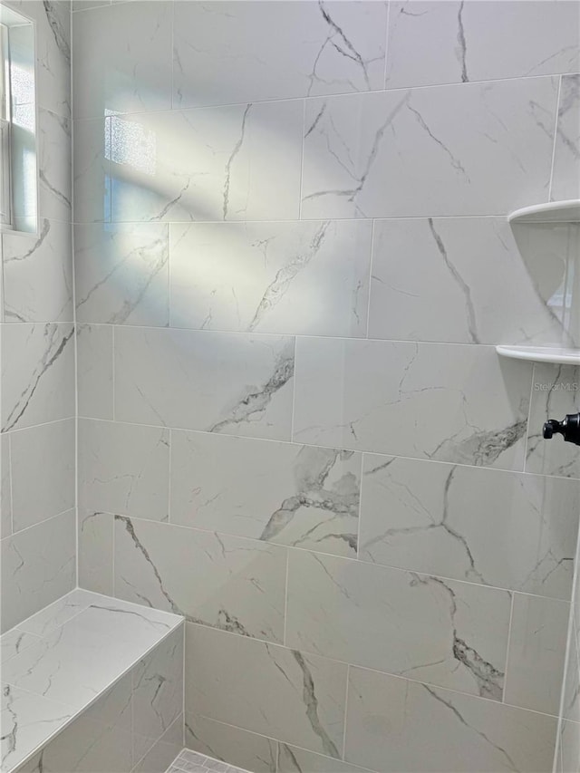 bathroom with tiled shower