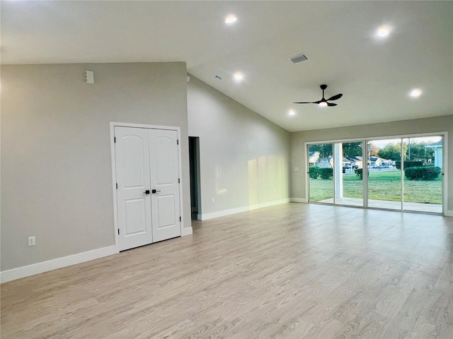 unfurnished room with ceiling fan, high vaulted ceiling, and light hardwood / wood-style floors