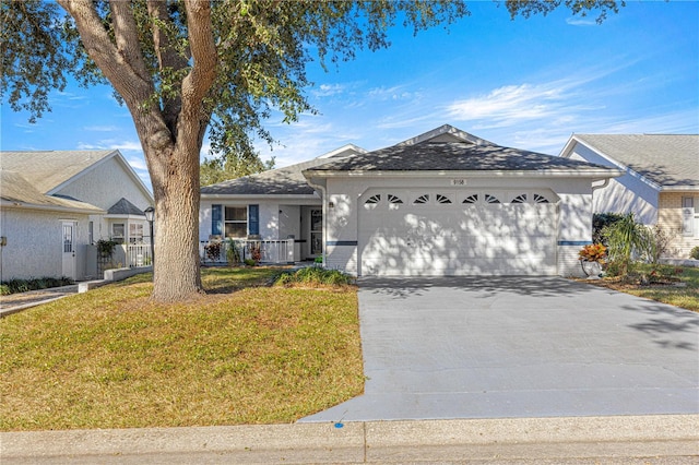 ranch-style house featuring a garage and a front yard