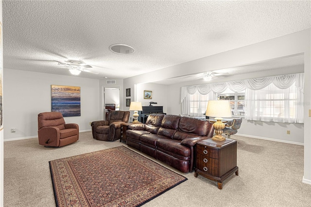 carpeted living room featuring a textured ceiling