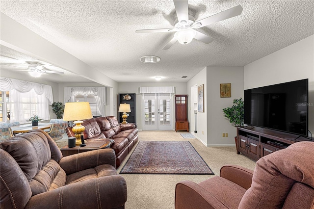 carpeted living room with french doors and a textured ceiling