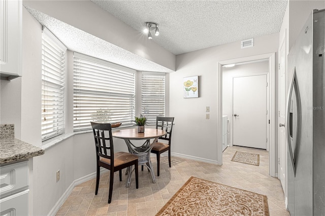 dining area with a textured ceiling