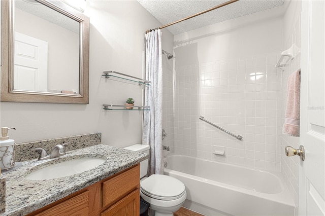 full bathroom featuring vanity, toilet, shower / bath combo, and a textured ceiling