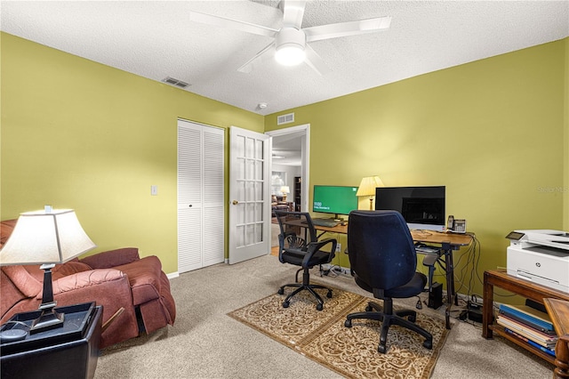 office area with ceiling fan, light colored carpet, a textured ceiling, and french doors