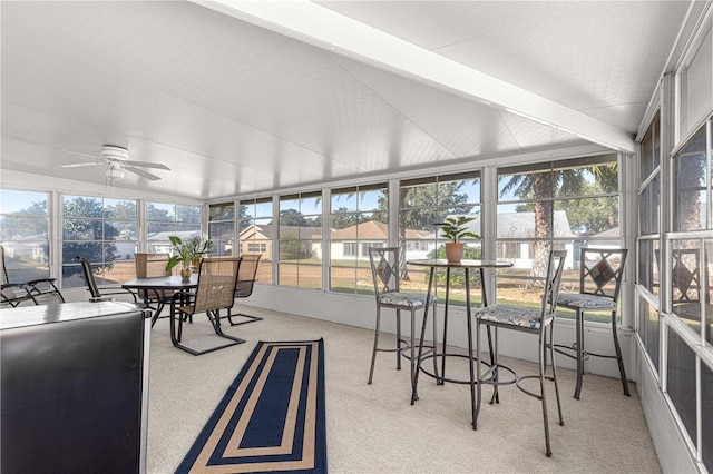 sunroom / solarium with vaulted ceiling with beams and ceiling fan