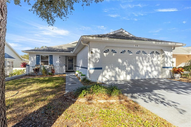 ranch-style home with a garage and a front yard