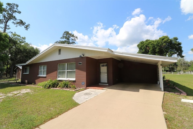 ranch-style house featuring a front lawn and a carport